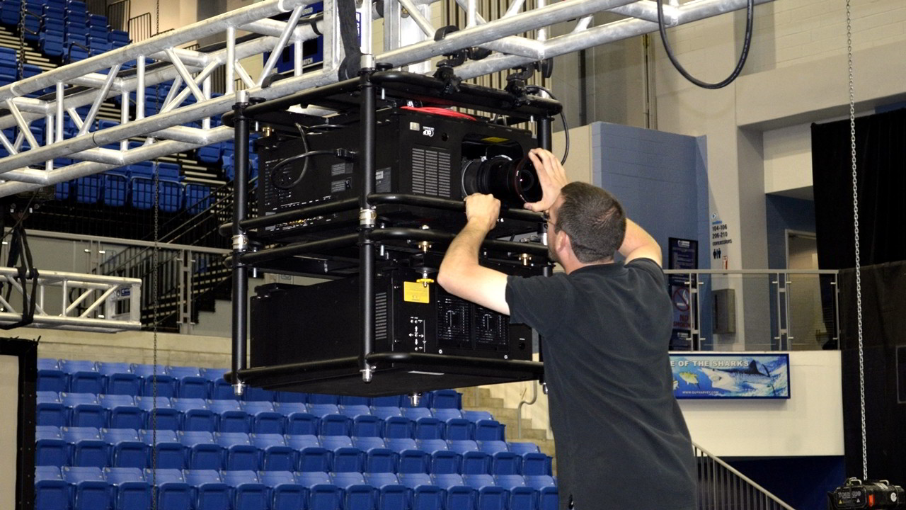 Sound Media Barco Double stacked projector lens being installed